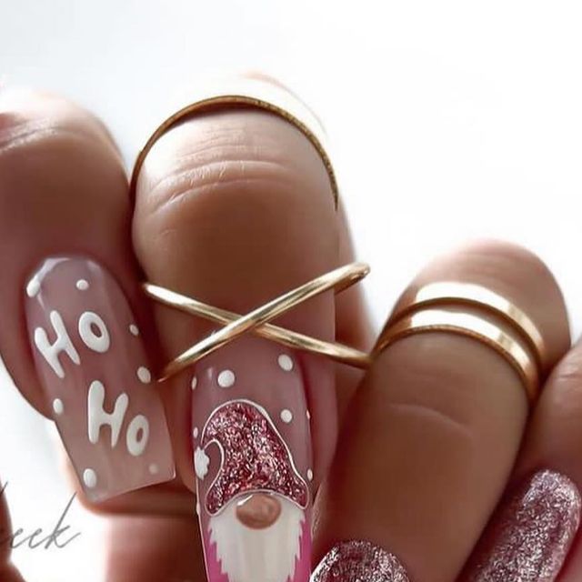 a manicure with pink and white designs on it