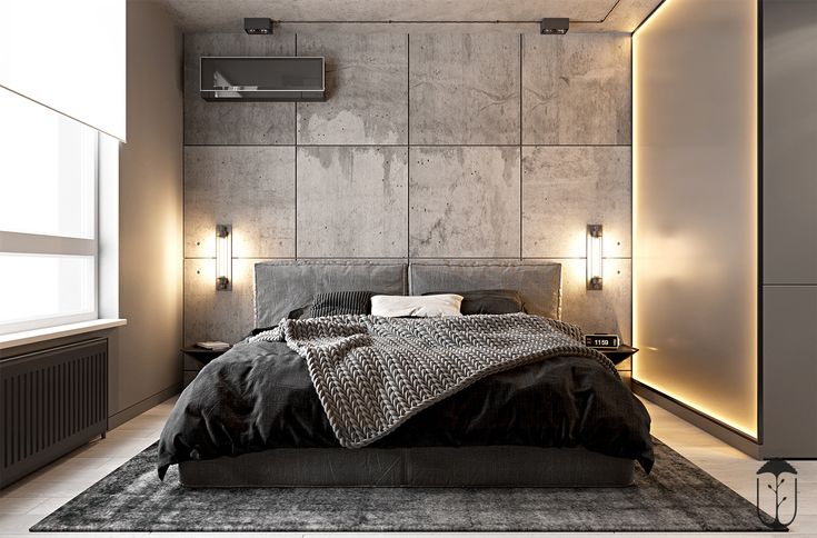 a modern bedroom with concrete walls and black bedding, lights on the headboard