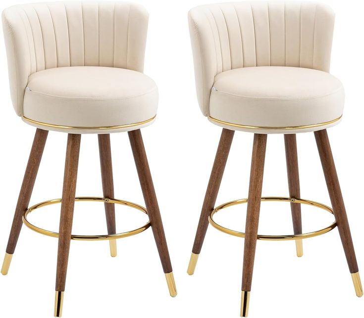 two white bar stools with wooden legs and gold trim on each side, one has a beige upholstered seat