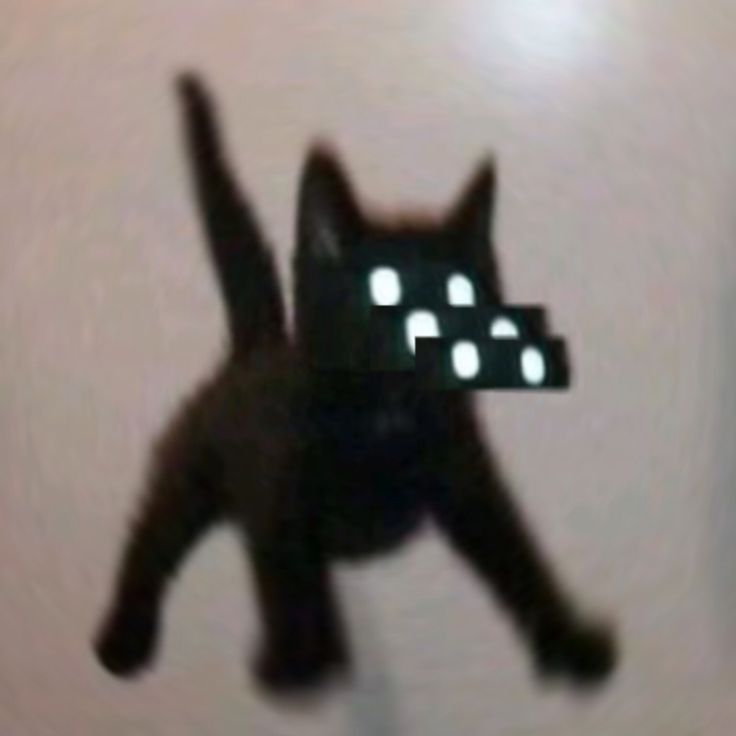 a black cat with glowing eyes jumping in the air