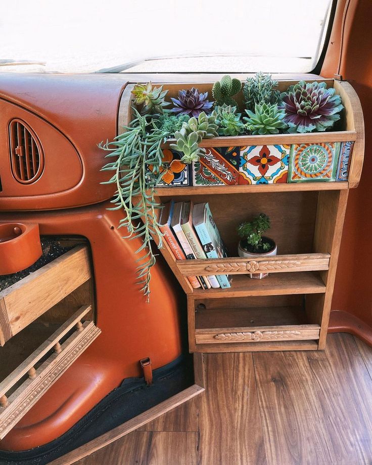 the interior of a vehicle with plants and books