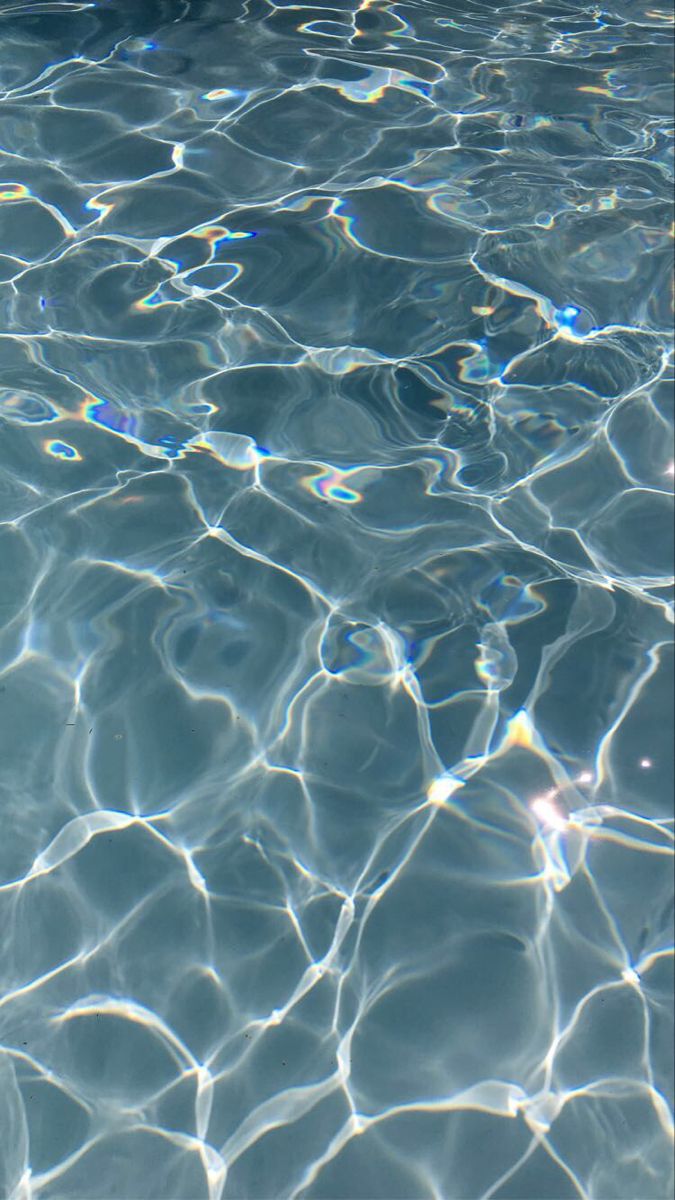 the water is very clear and blue with little ripples on it's surface