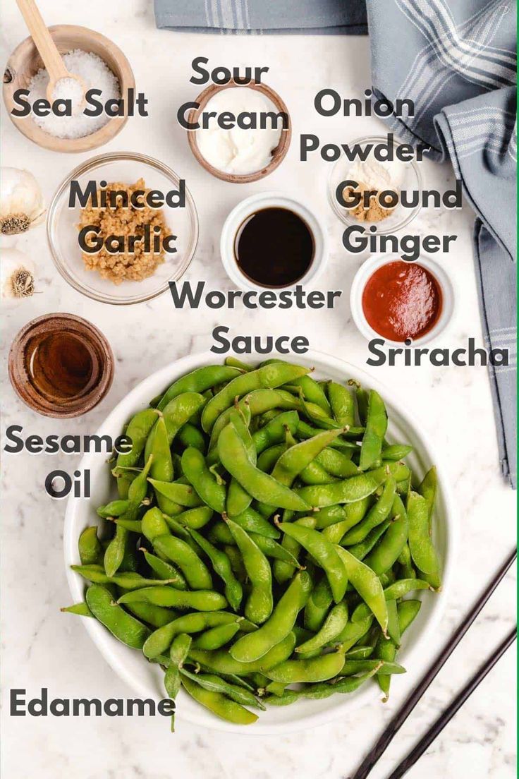 green beans in a white bowl with spices and seasonings on the side next to them