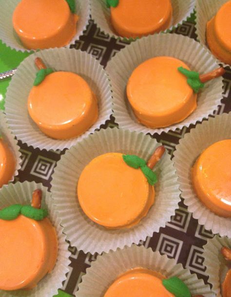 there are many cupcakes with orange frosting on them