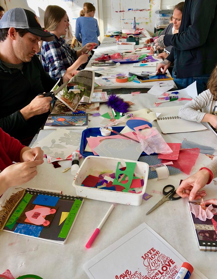 a group of people working on crafts at a table