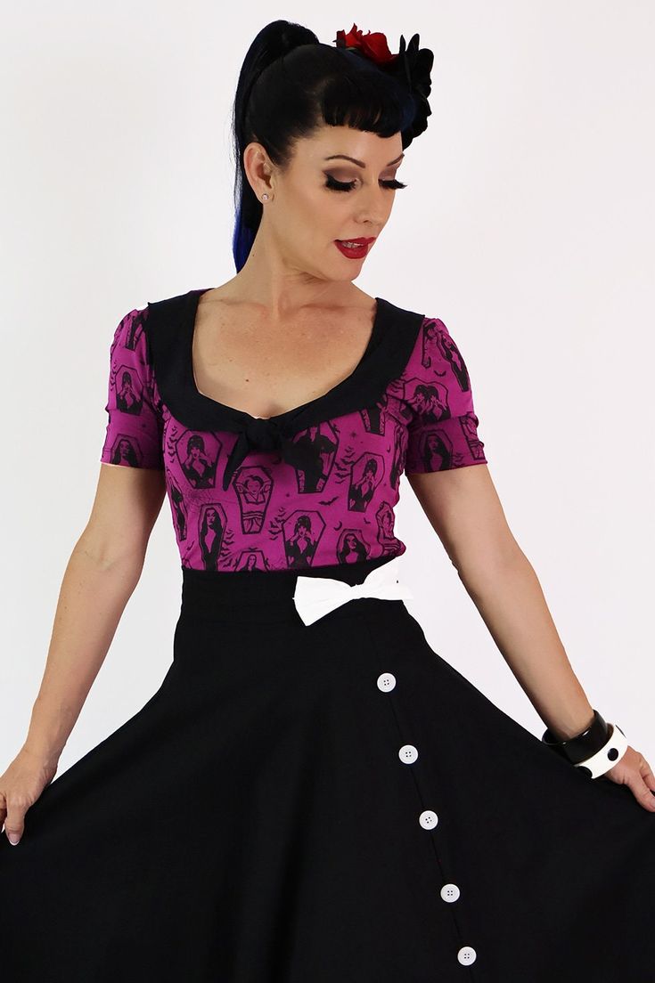 This statement top features the exclusive Ghoul Gang print with all your retro horror Queen faves. Featuring a contrast collar and tie this lovely top is a wonderfully spookyaddition to your wardrobe. The cut is fitted so if you like a looser fit please size up.  Made from soft viscose/cotton lycra  The fabric has good stretch, is super comfortable, and easy to wear. The Modest cut short sleeves cover the upper bicep. Model is 5.6' and wears a size 8 *Please note this style is currently availabl Fitted Graphic Print Tops For Costume Party, Fitted Spooky Graphic Print Top, Black Fitted Top With Peter Pan Collar, Spooky Fitted Graphic Print Tops, Fitted Rockabilly Tops With Graphic Print, Edgy Fitted Top For Costume Party, Horror Queen, Ghoul Gang, Retro Horror