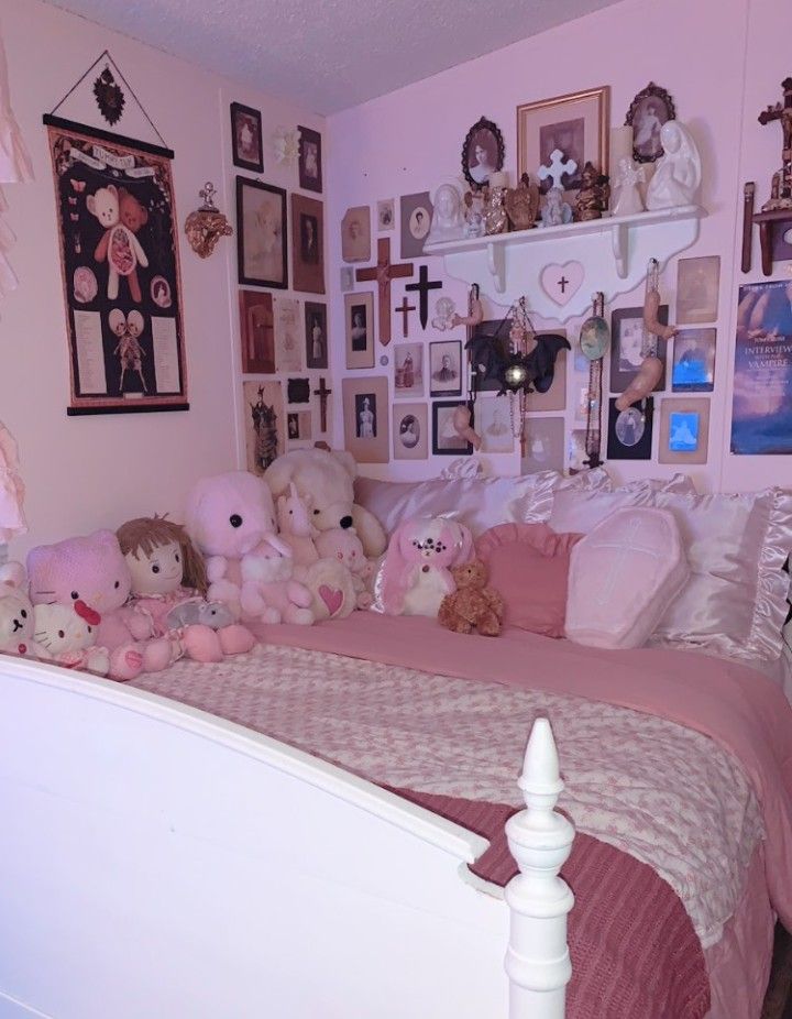 a bed with lots of stuffed animals on top of it in a room filled with pictures