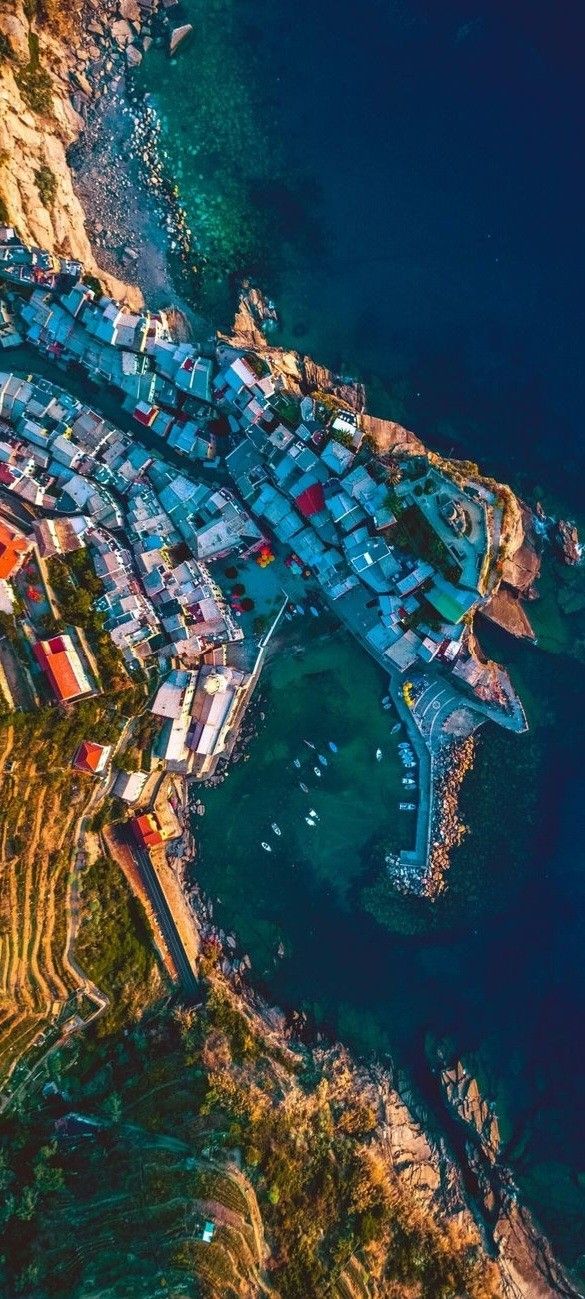 an aerial view of a small village by the ocean