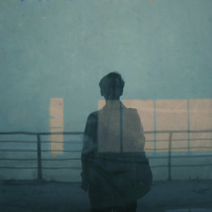 a person standing in front of a fence