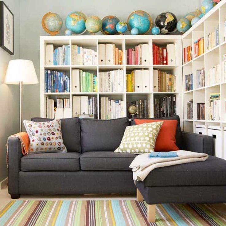 a living room filled with furniture and bookshelves covered in lots of different colored books