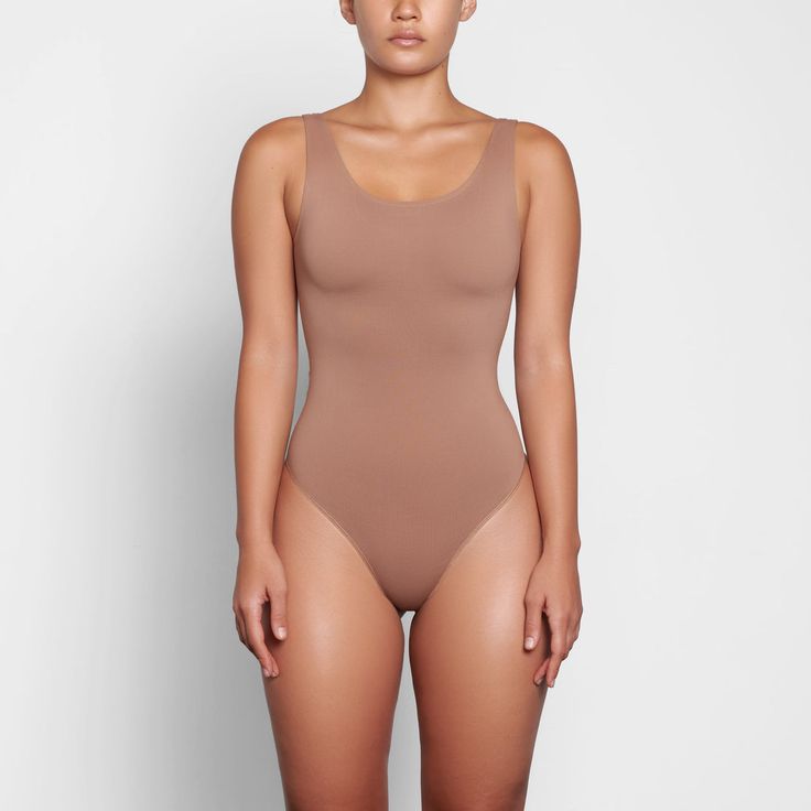 SOFT SMOOTHING THONG BODYSUIT | SIENNA Scoop Neck Shapewear With Built-in Bra, Stretch Leotard With Built-in Bra And Scoop Neck, Second-skin Scoop Neck Shapewear Swimwear, Solid Seamless Low Back Shapewear, Seamless Scoop Neck Shapewear For Summer, Second-skin Scoop Neck Leotard, Scoop Neck Second-skin Leotard, Seamless Stretch Shapewear With Low Back, Smoothing Scoop Neck Shapewear