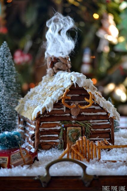 a christmas scene with a gingerbread house and trees