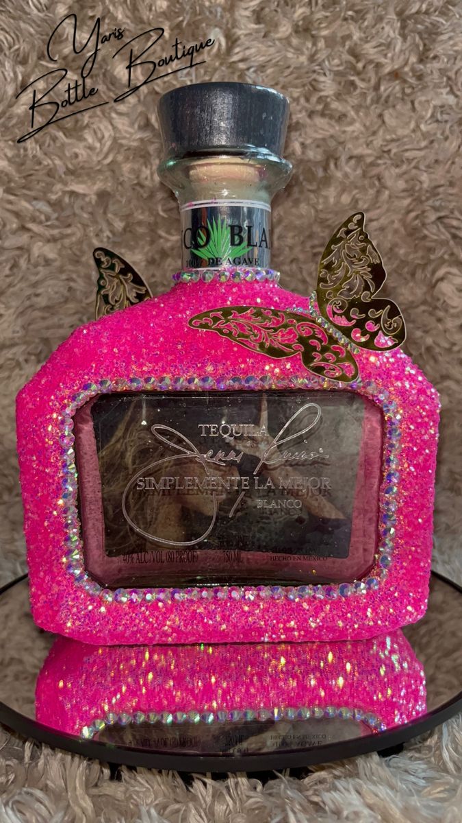 a pink bottle that has some decorations on it