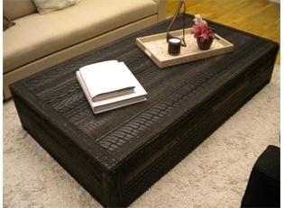 a living room with a couch, coffee table and two vases on the floor