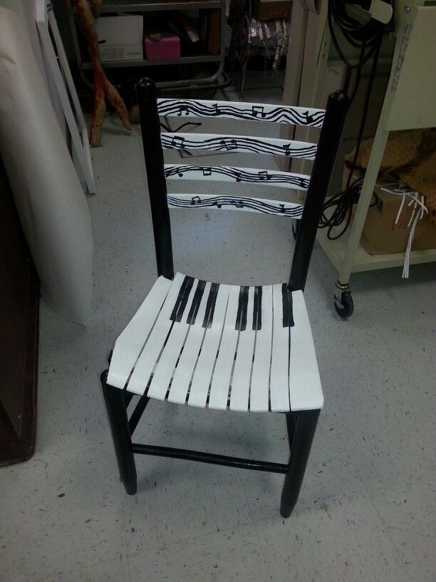 a white and black chair sitting on top of a floor