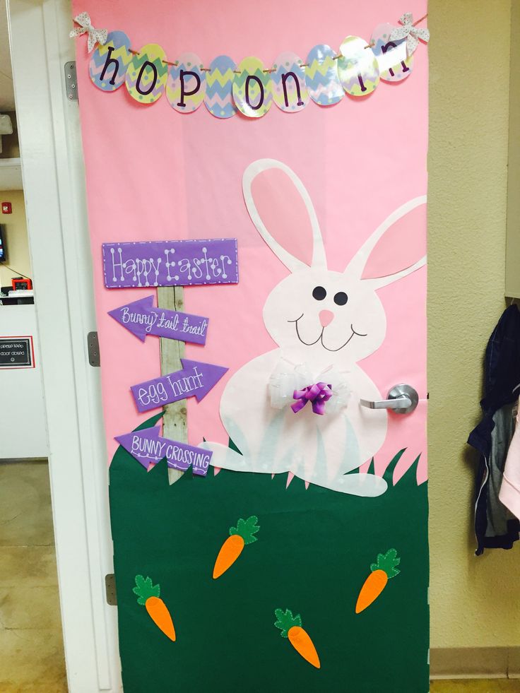 a door decorated with an easter bunny and carrots for the classroom's entrance