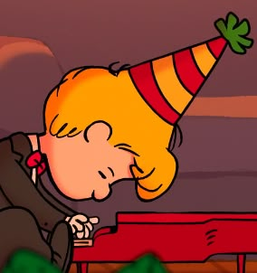 a cartoon character wearing a party hat blowing out a candle on top of a red bench