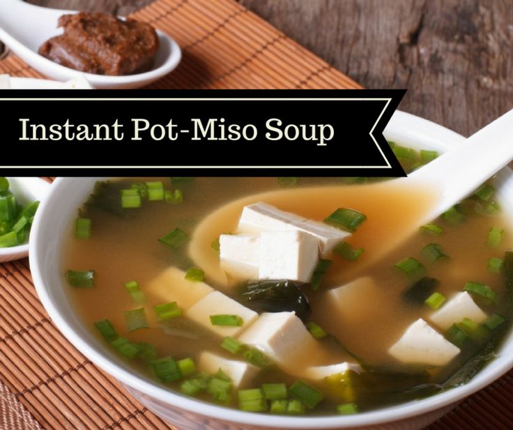 a bowl of miso soup with tofu and green onions