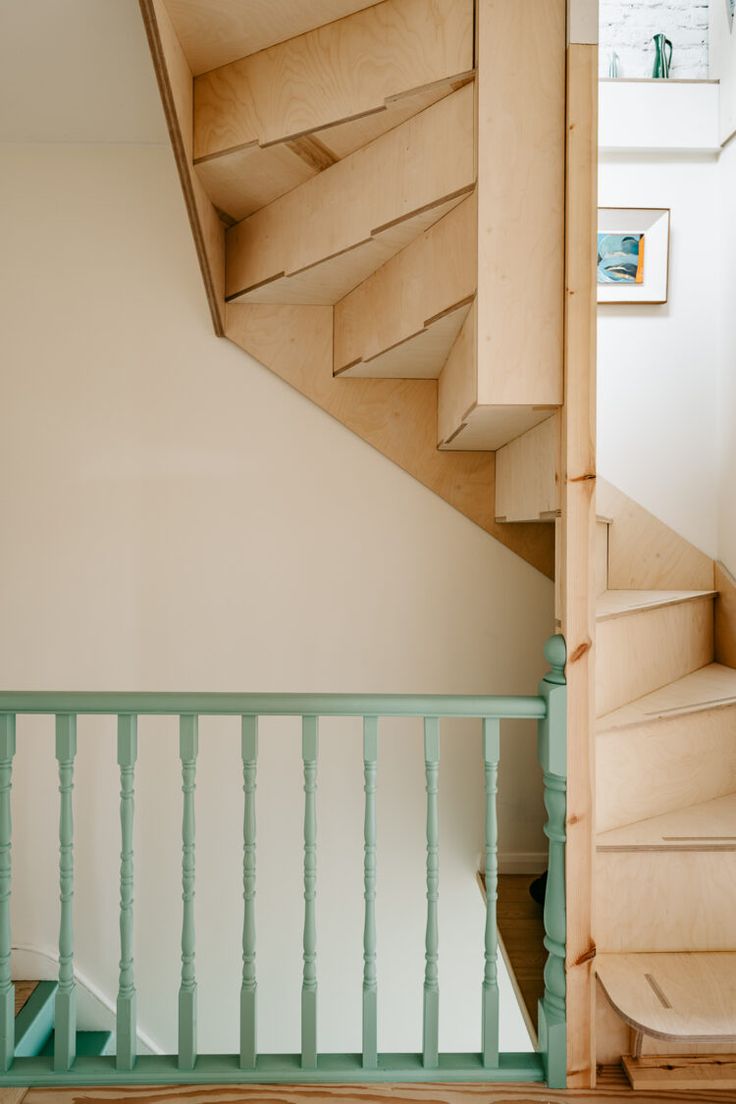 the stairs are made from plywood and have been painted light green with white trim