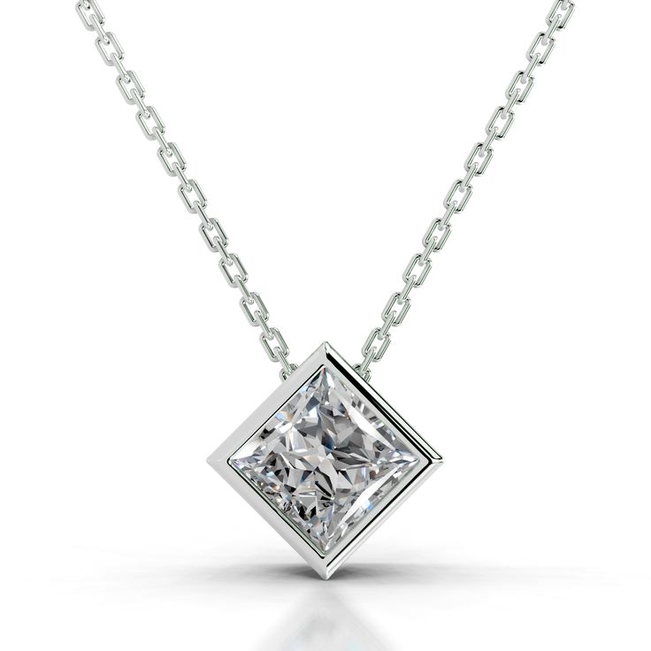 Introducing our exquisite Princess Solitaire Pendant, a dazzling embodiment of timeless elegance and modern sophistication. this pendant features a radiant princess-shaped diamond, meticulously set in a uniquely innovative design that sets it apart. The striking simplicity of the solitaire style accentuates the diamond's natural brilliance, making it the epitome of understated luxury. Luxury Timeless Solitaire Necklace, Dazzling Solitaire Diamond Pendant Necklace, Dazzling Diamond Solitaire Pendant Necklace, Luxury Diamond Cut Solitaire Pendant Necklace, Luxury Platinum Solitaire Pendant Necklace, Luxury Square Pendant Jewelry With Diamond Accents, White Gold Solitaire Pendant Necklace, Brilliant Cut, 5 Carat Ring, Girlfriend Anniversary Gifts