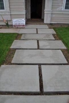 a cement walkway in front of a house