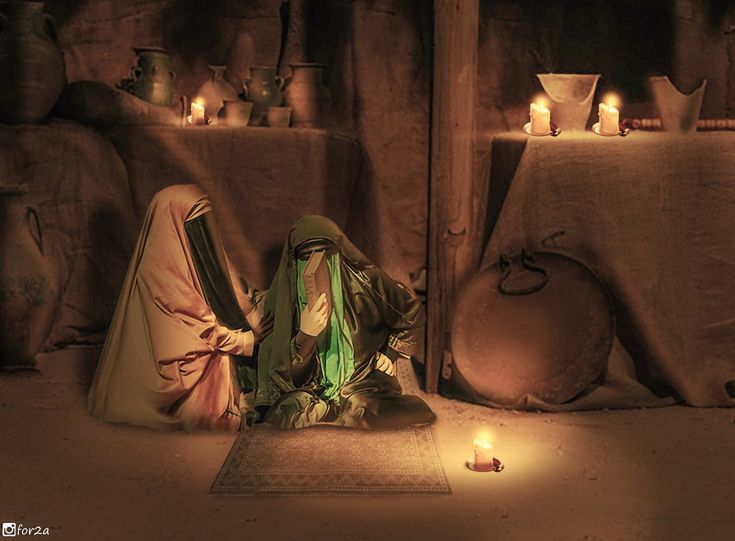 two women sitting on the ground in front of candles