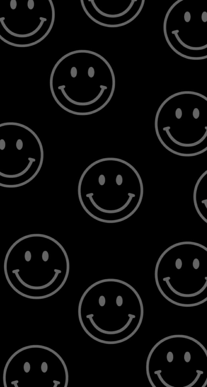 a black background with white smiley faces