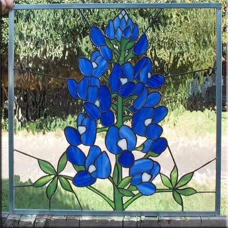 a stained glass window with blue flowers on it