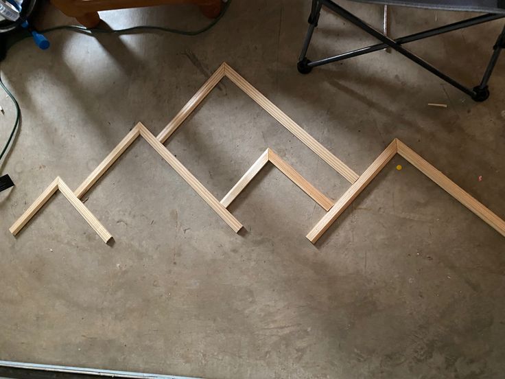 some wooden frames are laying on the floor