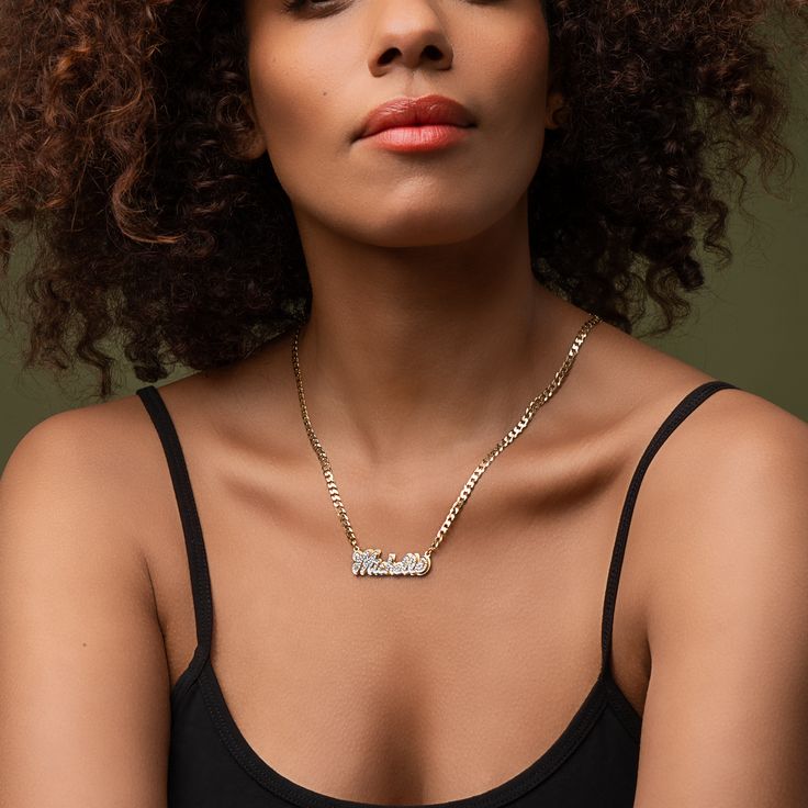 Our popular Double Plated Iced Out Script Name Necklace boasts a chic and elegant design, handcrafted to perfection. The model showcases the necklace with an 18-inch Cuban chain (see image for reference). Chain width:Cuban Chain - 3.7 mmFigaro Chain - 3 mmRope Chain - 2.3 mm Closure: All chains are fitted with a lobster clasp. Metal Selection: Gold Plated Silver Plated Sterling silver 14k gold plated over sterling silver 14k solid gold - (NAMEPLATE ONLY) Curb Chain Pendant Necklace, Elegant Personalized Link Necklaces, Elegant Engraved Cuban Link Jewelry, Pendant Necklace With Curb Chain As Gift, Metal Name Necklace With Adjustable Chain Pendant, Elegant Nameplate Necklace With Figaro Chain, Metal Nameplate Necklace With Adjustable Chain, Elegant Nameplate Curb Chain Necklace, Metal Pendant Name Necklace With Adjustable Chain