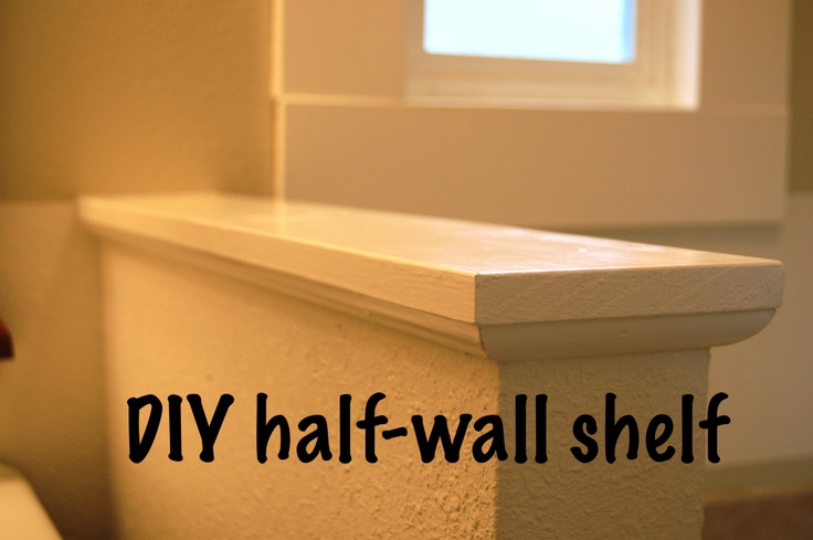 a white toilet sitting in a bathroom next to a window with the words diy half - wall shelf above it