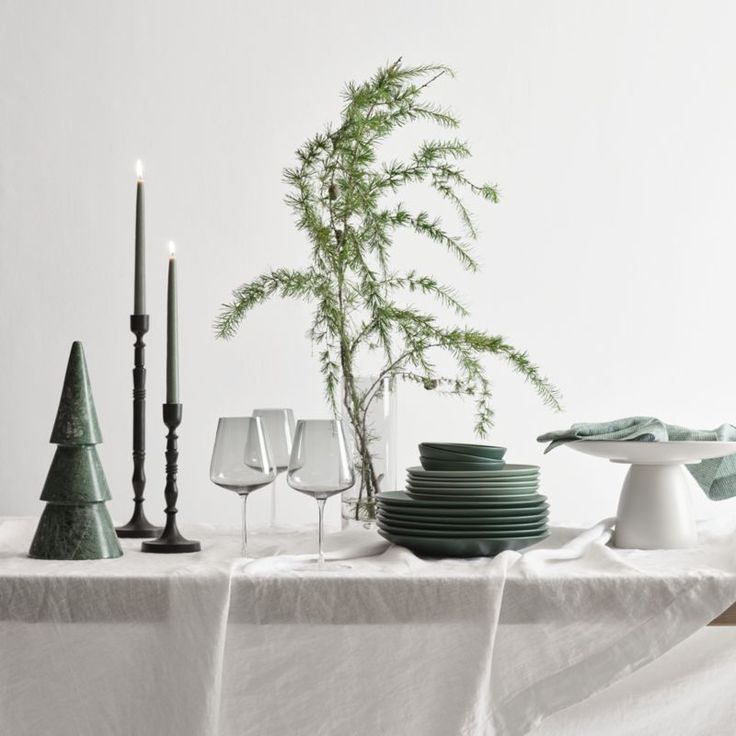 a white table topped with plates and glasses