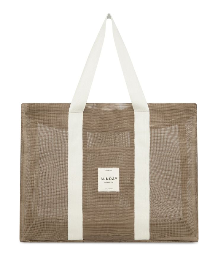 a brown and white tote bag on a white background