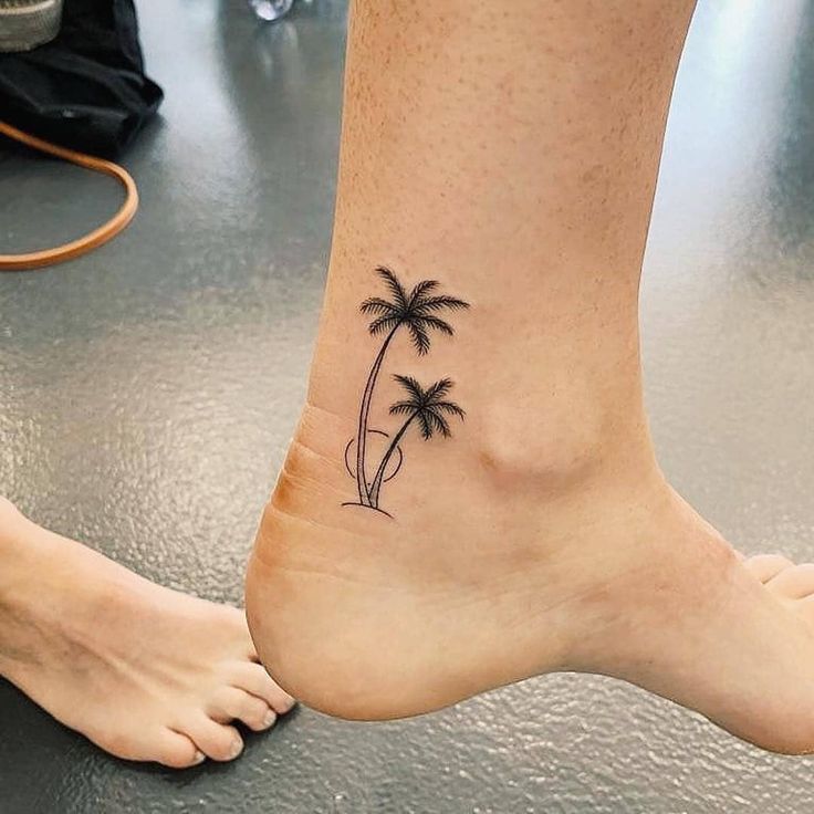 a small palm tree tattoo on the ankle