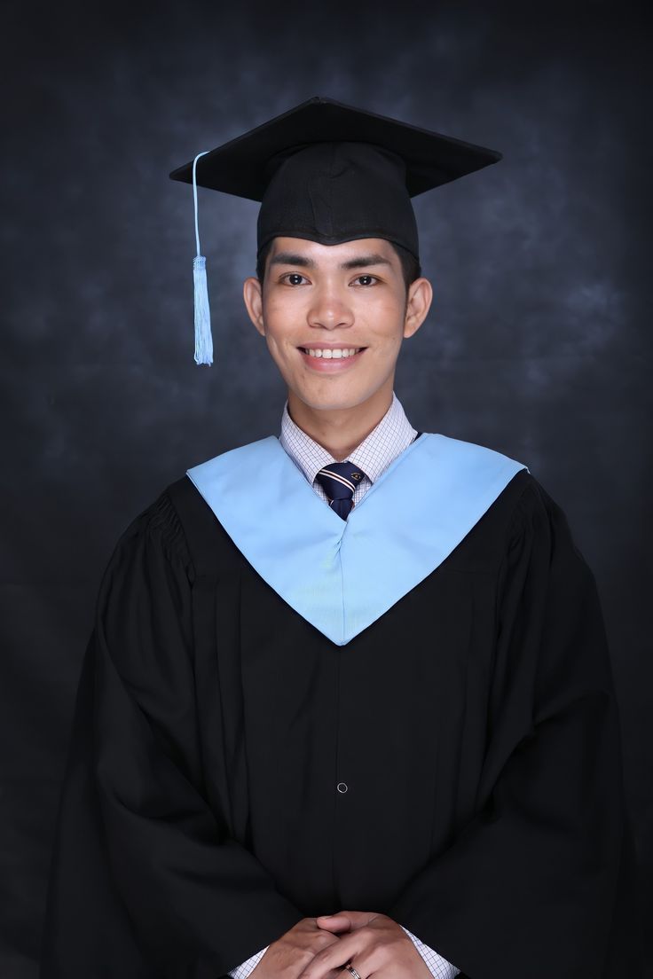 a young man wearing a graduation cap and gown