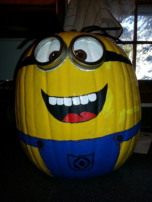 a yellow and blue pumpkin with googly eyes