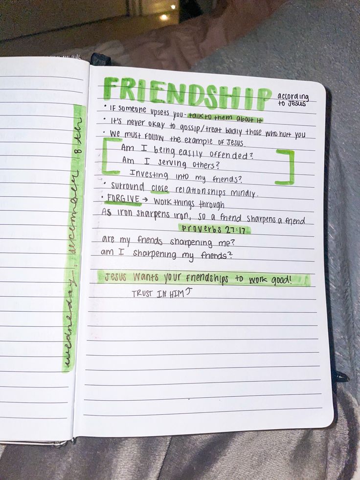 an open notebook with green writing on it