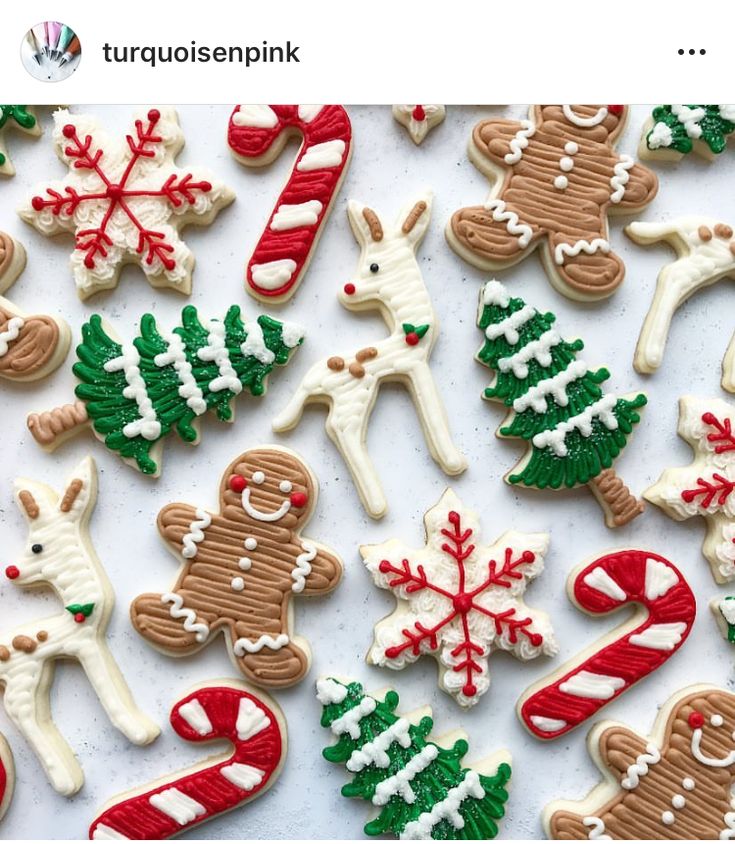 decorated cookies are arranged on a white surface