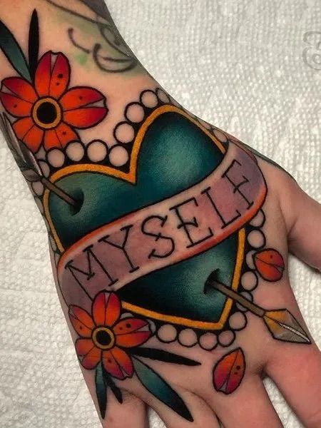 a person's hand with a tattoo on it and a heart that says my self