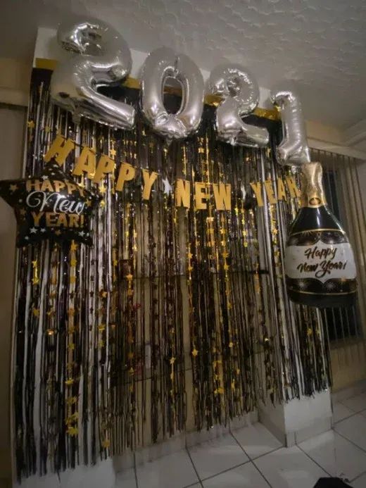 balloons and streamers decorate the entrance to a new year's eve party with champagne