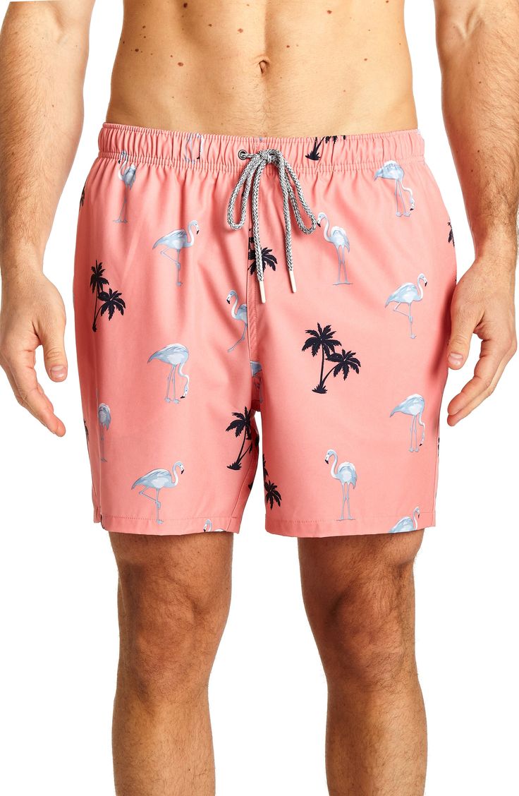 An easy and fun flamingo print defines smart swim trunks cut from stretchy quick-drying fabric. 24" leg opening; 6" inseam (size M) Elastic drawstring waist Side pockets All-over print Woven 92% polyester, 8% spandex Machine wash cold, tumble dry low Imported Model stats: 6'1" height, 32" waist. Model is wearing size M. Summer Vacation Bottoms With Graphic Print, Casual Patterned Swimwear For Beach Season, Printed Patterned Bottoms For Beach Season, Summer Vacation Graphic Print Bottoms, Casual Patterned Swimwear For Spring, Graphic Print Beach Bottoms For Summer, Casual Stretch Swimwear With Tropical Print, Fitted Printed Bottoms For Vacation, Casual Pink Bottoms With Graphic Print