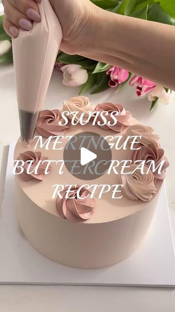 someone is cutting into a cake with pink icing and flowers in the background that reads, seuss not quite butter cream recipe