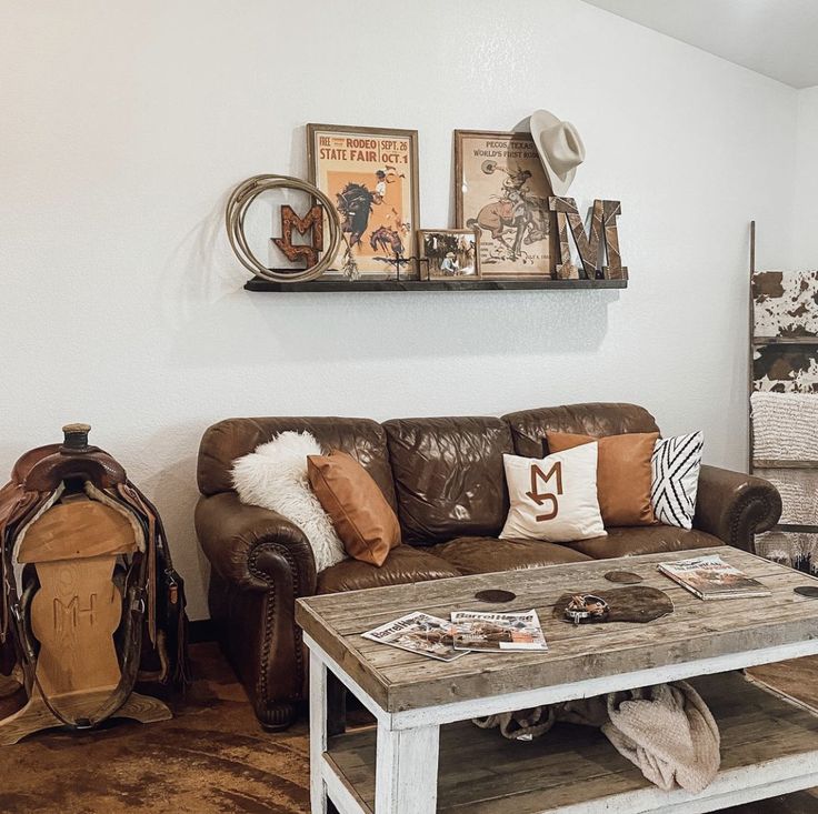 a living room filled with furniture and decor on top of a hard wood floored floor