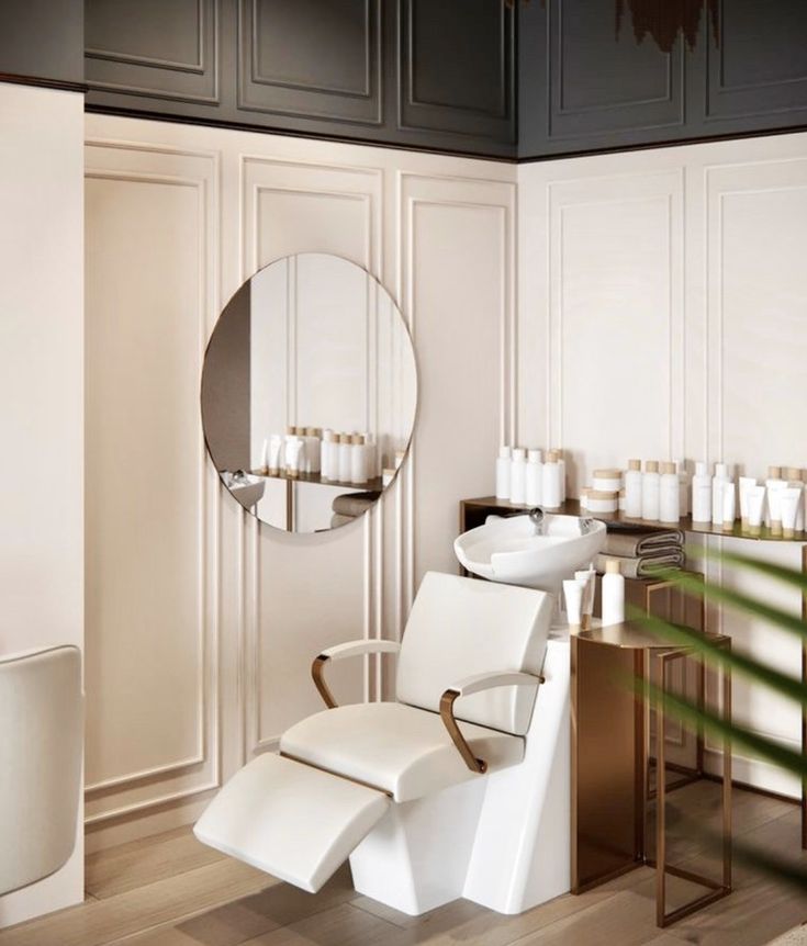 a white chair sitting in front of a mirror next to a table with candles on it