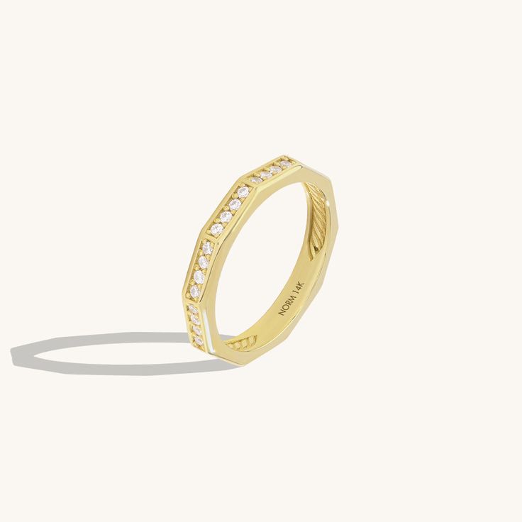 Elevate your hand with our Faceted Eternity Ring. This exquisite design radiates timeless beauty with its intricate design. The faceted surfaces reflect light brilliantly, creating a mesmerizing sparkle that symbolizes eternal love and elegance. Whether worn as a symbol of commitment or as a dazzling statement piece, this ring adds a touch of sophistication to any look. - Made in 14k solid gold - Decorated with handset white cubic zirconia stone on 14k solid gold - Band Width: 2.85 mm / 0.11 inc Modern Octagon Diamond Cut Diamond Ring, Modern Octagon Diamond Cut Ring, Luxury Octagon Diamond Promise Ring, Luxury Diamond White Octagon Ring, Luxury Octagon Diamond Cut Rings, Timeless Octagon Diamond White Ring, Luxury Octagon Diamond White Ring, Luxury Octagon Diamond Ring With Single Cut Diamonds, Luxury Octagon Diamond Anniversary Ring