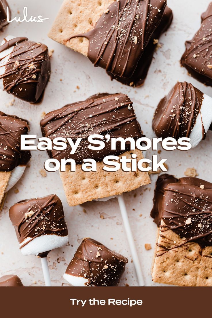 chocolate covered marshmallows and graham crackers arranged on a white tray with toothpicks