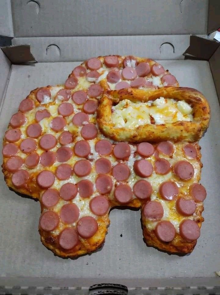 a pizza with pepperoni and cheese cut into the shape of an elephant in a box