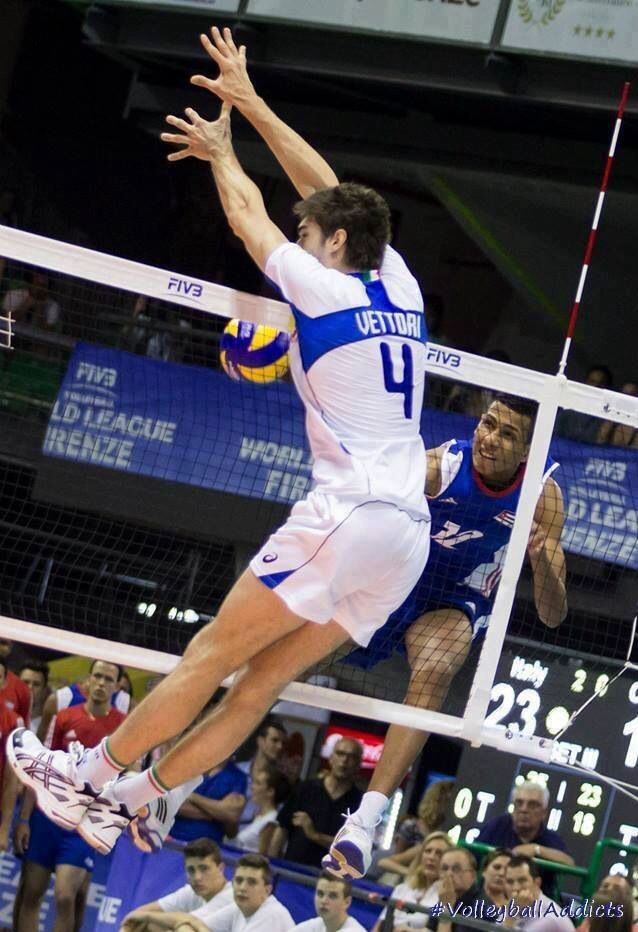 a man jumping up to hit a volley ball