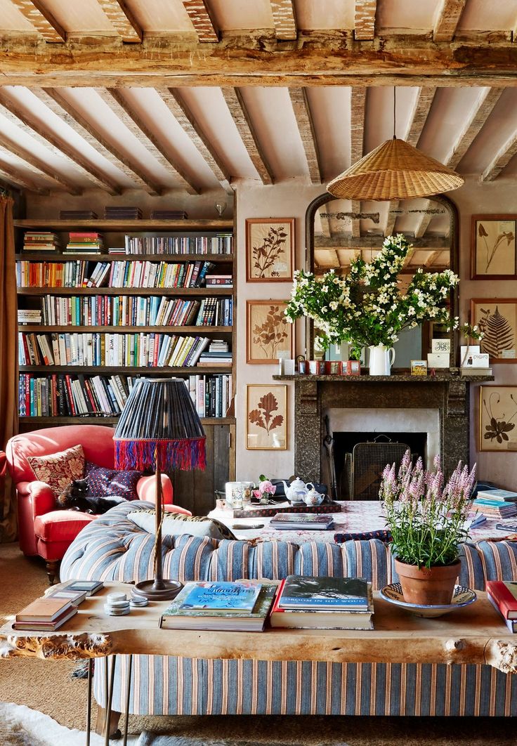 a living room filled with lots of books and furniture