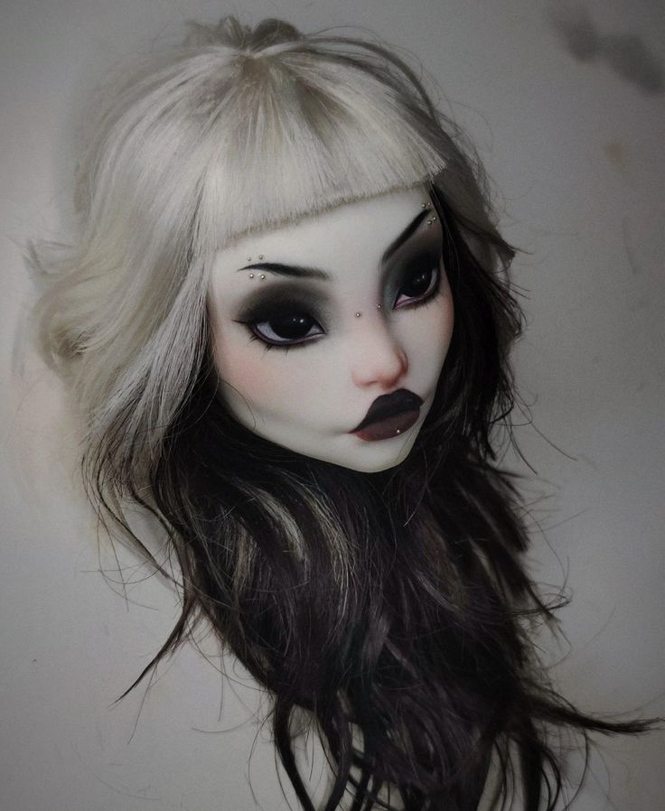 a doll with white hair and black makeup